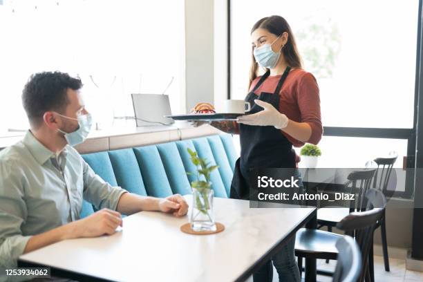 Waitress Serving Order To Customer In Cafe Stock Photo - Download Image Now - Restaurant, Coronavirus, Protective Face Mask