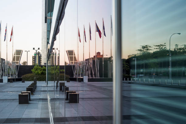 istock Reflection of office park in the glass facade 1253934868