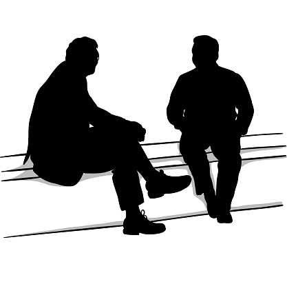 Two men sitting on a bench deep in conversation