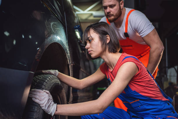 istock Female car technician intern changing a tire 1253943521