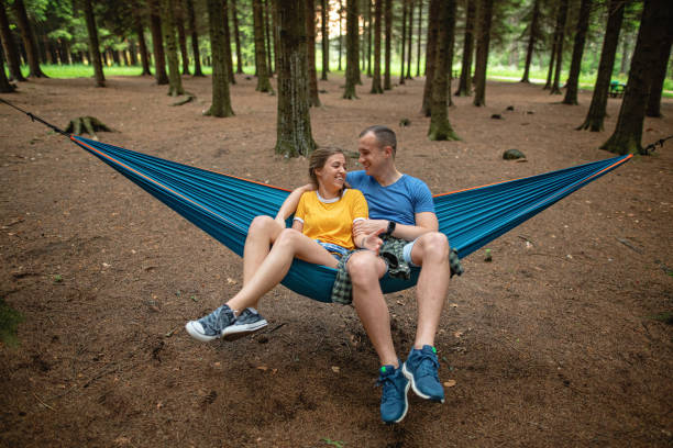 istock Adventurous couple relaxing in a hammock together 1253944110