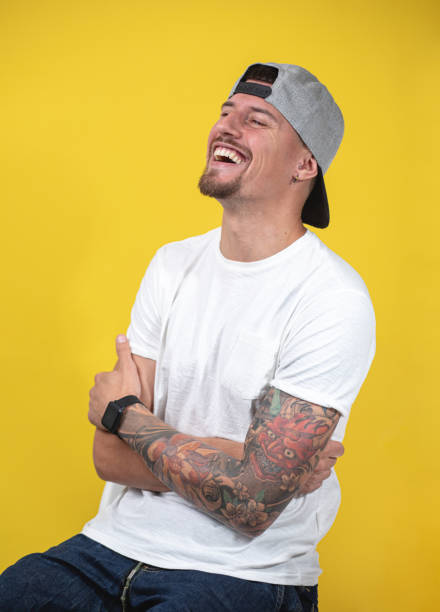 istock Cheerful skater showing off his tattoos 1253944137
