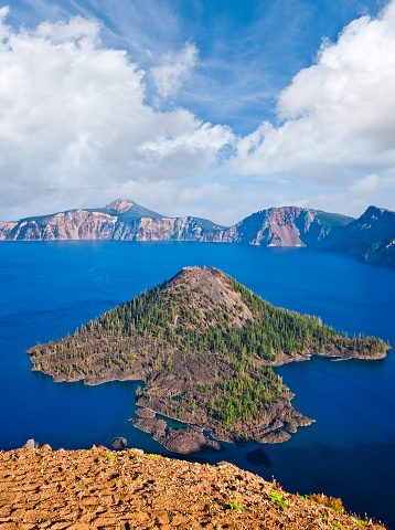 Crater Lake exists in the blown-out caldera of a once mighty volcano known as Mount Mazama. This view of the lake and Wizard Island was taken from Watchman Overlook in Crater Lake National Park, Oregon, USA.