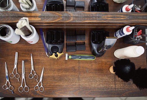 Barber shop scissors and essential tools placed on a wooden table