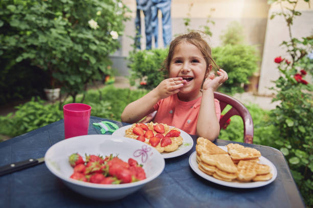 istock Cheerful girl eating sweet breakfast 1253944209