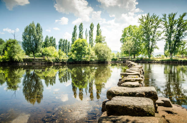 Roman stepping stones in Chaves. Portugal. Ancient Roman stepping stones cross the Tâmega river in the city of Chaves. Portugal. bridge crossing cloud built structure stock pictures, royalty-free photos & images
