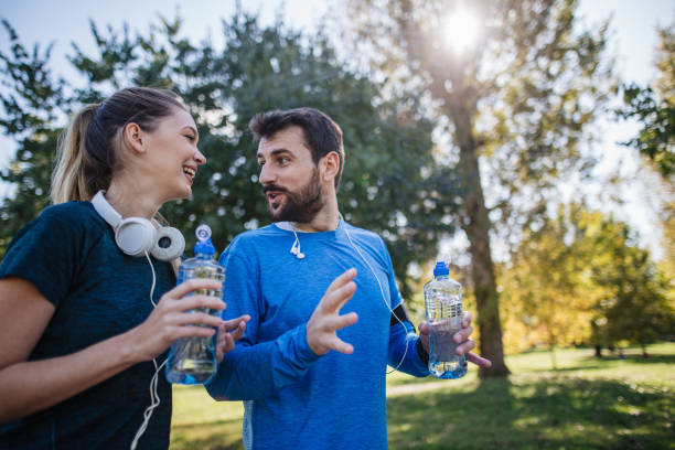 istock Handsome man storytelling while on a morning walk with a woman 1253944373