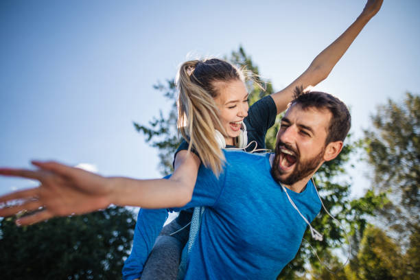 istock Athlete couple laughing while playing in a public park 1253944381