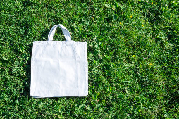 istock Eco bag on green grass. Textile bag for shopping. Zero waste. 1253947410