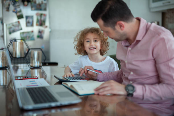 businessman and son working in home office businessman and son working in home office things that go together stock pictures, royalty-free photos & images