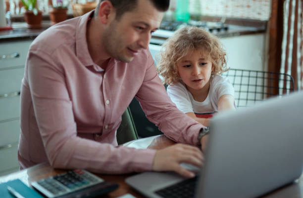 istock man and child working in home office with laptop 1253949352