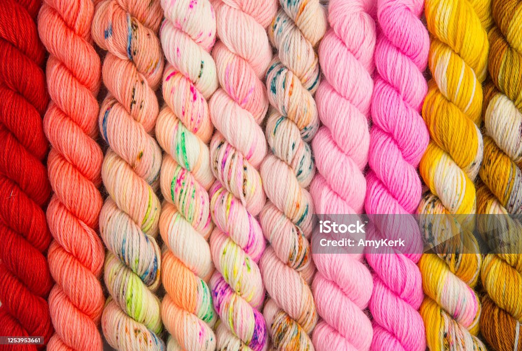 Warm colors of twisted yarn Warm colored hues of yarn twisted into hanks Ball Of Wool Stock Photo