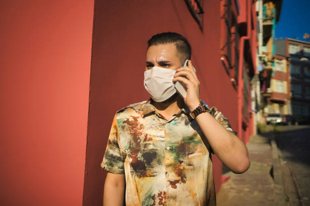 istock men Wearing protective face using mobile phone  in balat/Istanbul 1253954596
