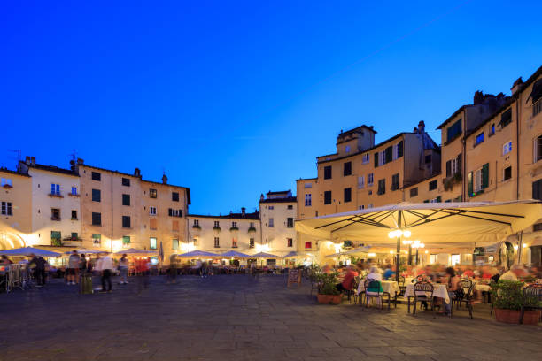 istock Square of Anfiteatro Lucca Italy by sunset 1253954652