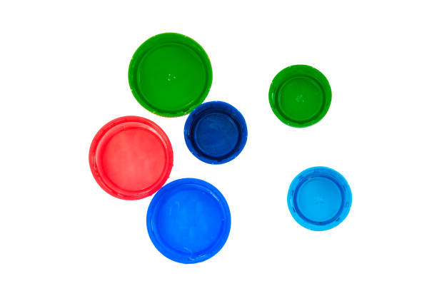 istock Plastic bottle caps isolated on white background. Red, blue and green lids top view 1253955527