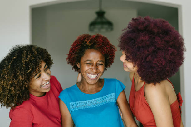 istock Smiling curly women at home 1253956567