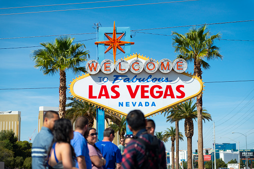 People wait in line to pose for a picture in front of the Welcome to Las Vegas sign in Las Vegas, Nevada.