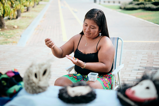 Indigenous Woman Beading Flower Coaster At Souvenirs Stall For Tourists, Ciudad De Panama, Panama