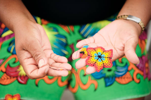 Indigenous Woman Beading Flower Coaster At Market Stall For Tourists Closeup Of Indigenous Woman Beading Flower Coaster At Souvenirs Stall For Tourists, Ciudad De Panama, Panama Bead stock pictures, royalty-free photos & images