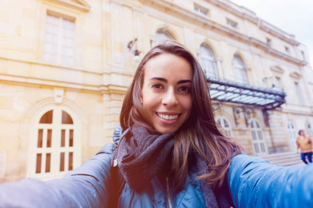 istock Latin american cheerful backpacker taking a selfie 1253961568