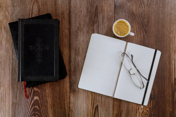 istock Open Holy Bible lying on personal study with a cup of coffee 1253967535