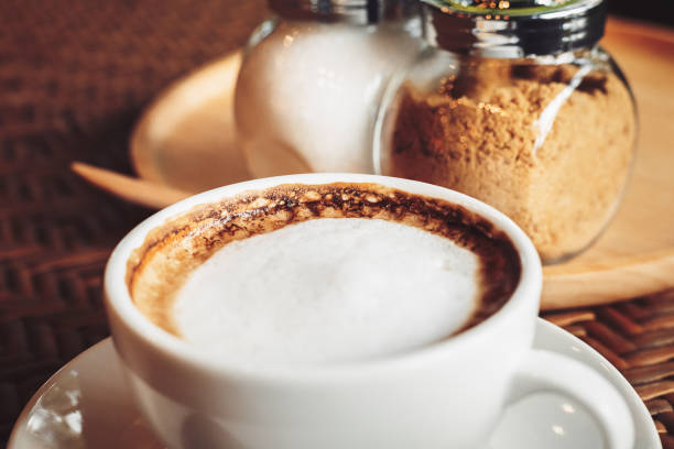 istock hot cup of coffee on the wood table. 1253967607