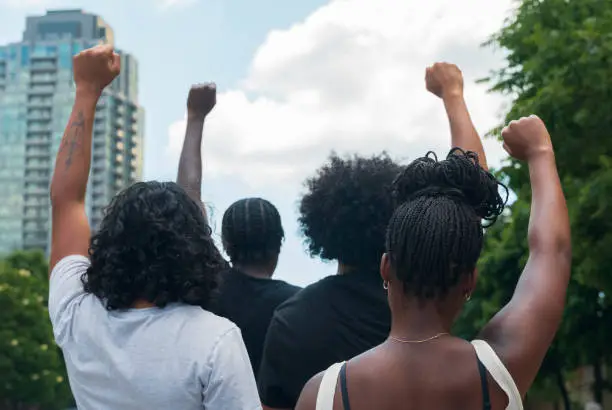 A group of African American people protest racial injustice in light of protest.