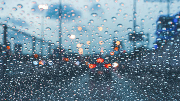 istock driving car on metropolis road in trafic jam with raindrop over the wind shield 1253968224