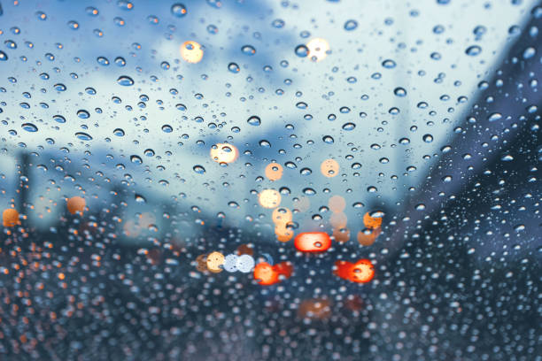 istock driving car on metropolis road in trafic jam with raindrop over the wind shield 1253968225