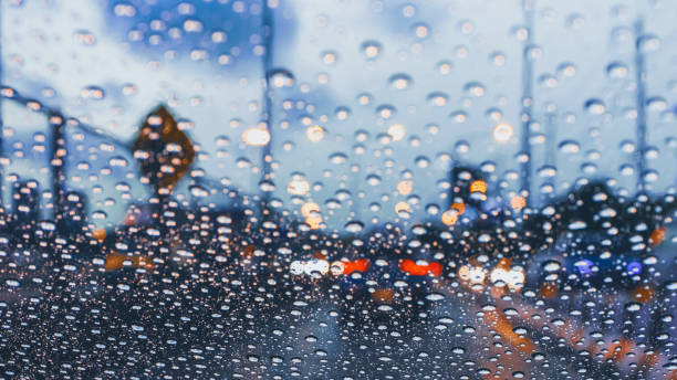 istock driving car on metropolis road in trafic jam with raindrop over the wind shield 1253968228
