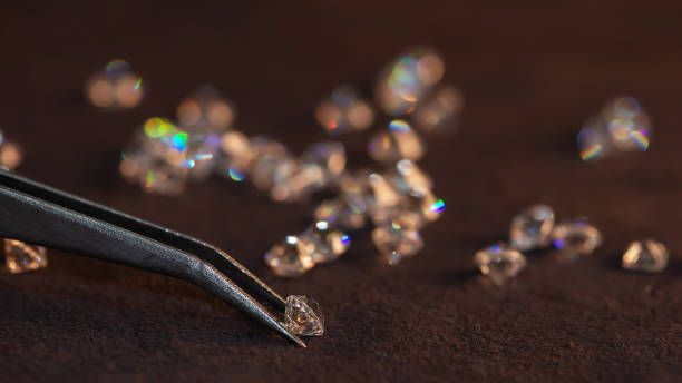 istock Diamond with tweezers and magnifier.Gemstone Beauty 1253968442