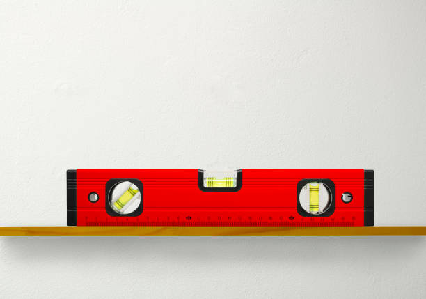 istock Bubble level with a wooden shelf on white wall 1253969666
