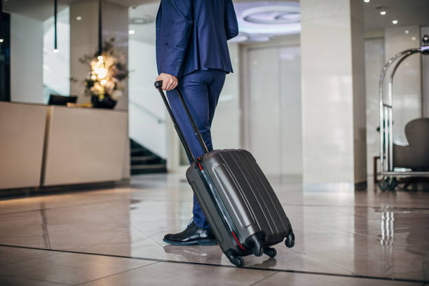 istock Modern man in blue suit arriving in hotel 1253970411