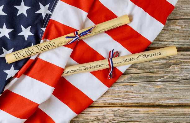 istock American holiday. Declaration of Independence parchment roll document with US flag. 1253970957