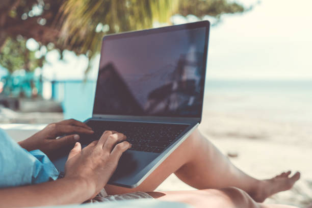 woman using laptop and smartphone to work study in vacation cady at beach background. business, financial, trade stock maket and social network concept. - on beach laptop working imagens e fotografias de stock