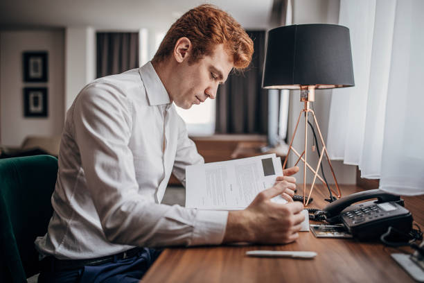 istock Businessman in hotel room 1253971856