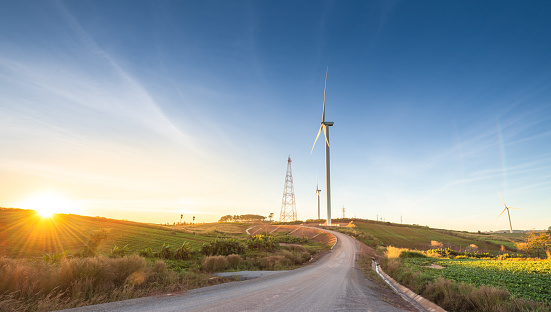 Nature wind turbines and solar panels with high voltage electricity power line for clean energy in mountains