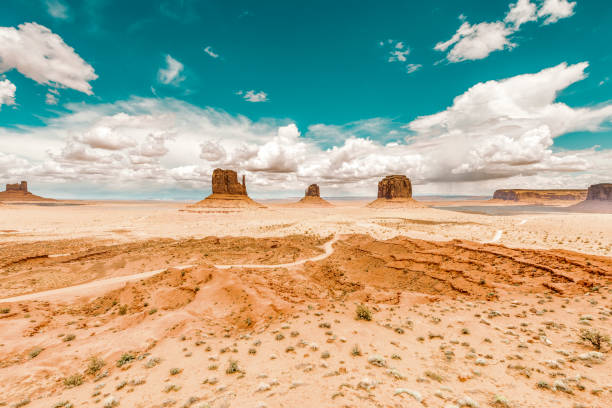 Monument Valley desert in southwest USA A red-sand desert region on the Arizona-Utah border known for the towering sandstone buttes. the mittens monument valley stock pictures, royalty-free photos & images