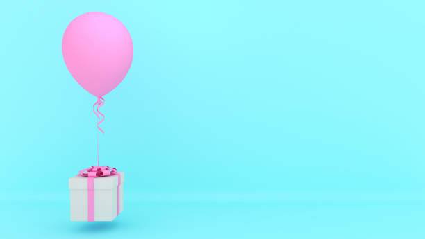 istock White gift box with red ribbon and pink balloon on blue background. 1253979174