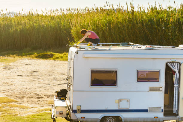 istock Woman cleaning caravan roof 1253989801