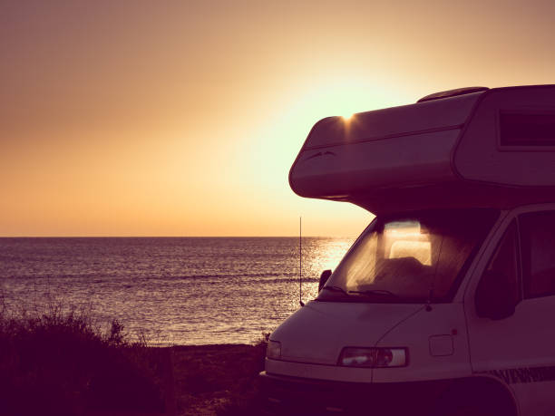 istock Camper rv on sea at sunrise 1253989963