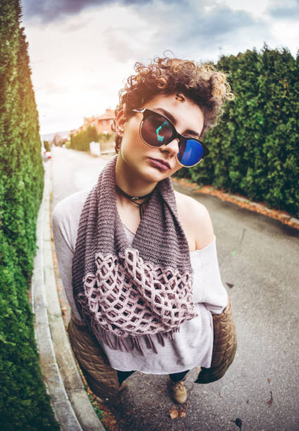 Young beautiful Caucasian woman posing with fly sunglasses.