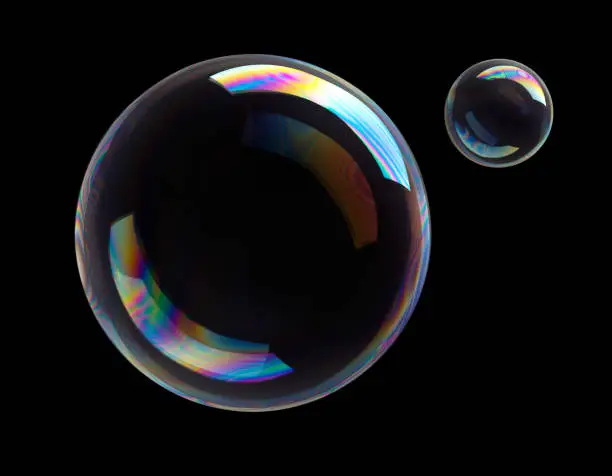 Two colorful soap bubbles flying on black background