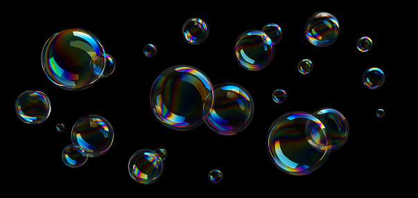 Group of colorful soap bubbles flying on black background
