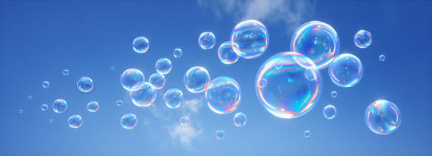 istock Soap bubbles flying in the blue sky 1253992338