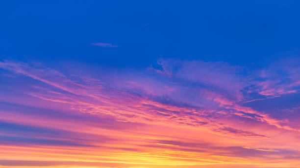 istock Bright blue sky with red-yellow clouds. Summer sunset. 1253996471