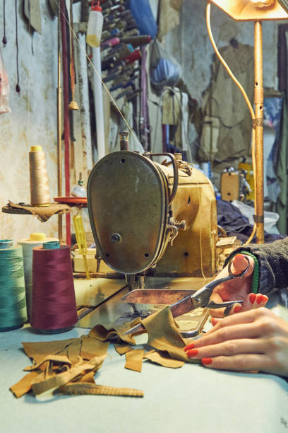 istock Woman tailor using retro sewing machine at home, hobby concept. 1253999232