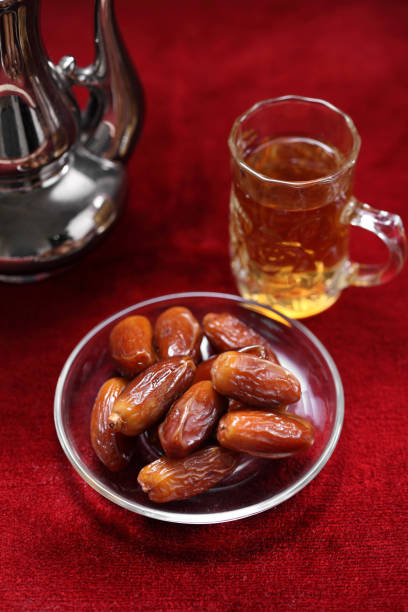 istock Dates fruit on carpet background, Islamic background in mosque 1254001831