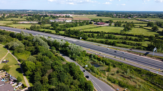 Reading, United Kingdom - May 25 2020:  Aerial view of the M4 motorway as it passes by the Reading Suburb of Whitley Wood at Junction 11