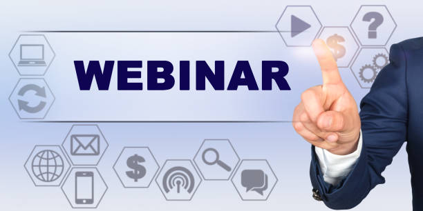 istock Businessman touching virtual screen with his finger. Screen caption - WEBINAR 1254002488